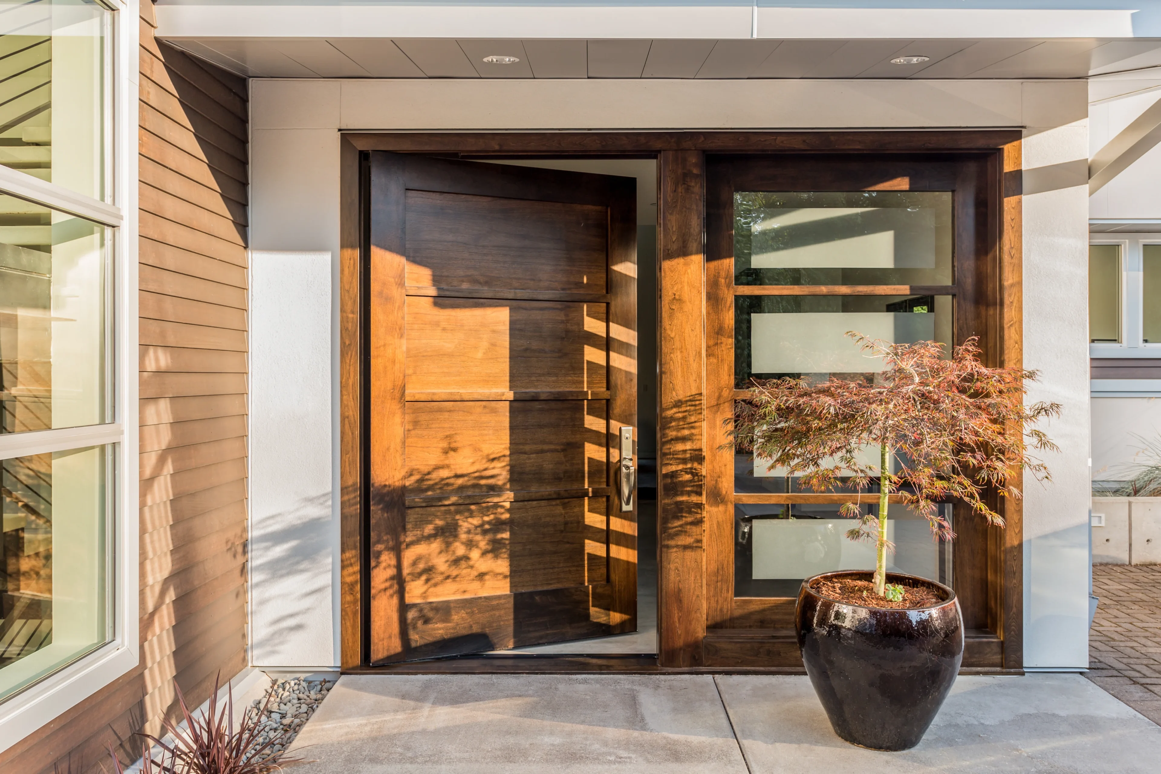 Modern dark wood front door open.