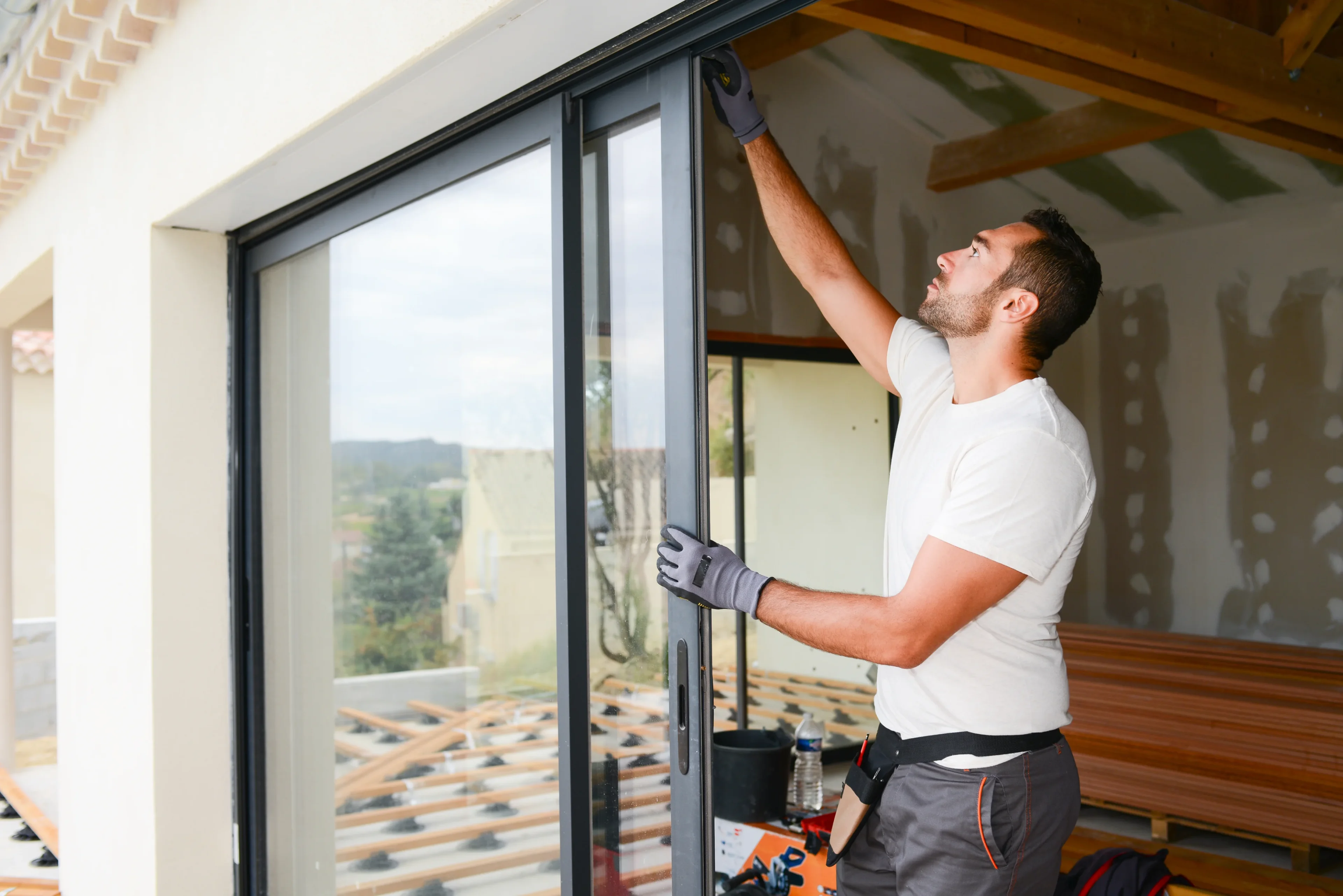 Worker installing sliding glass door.